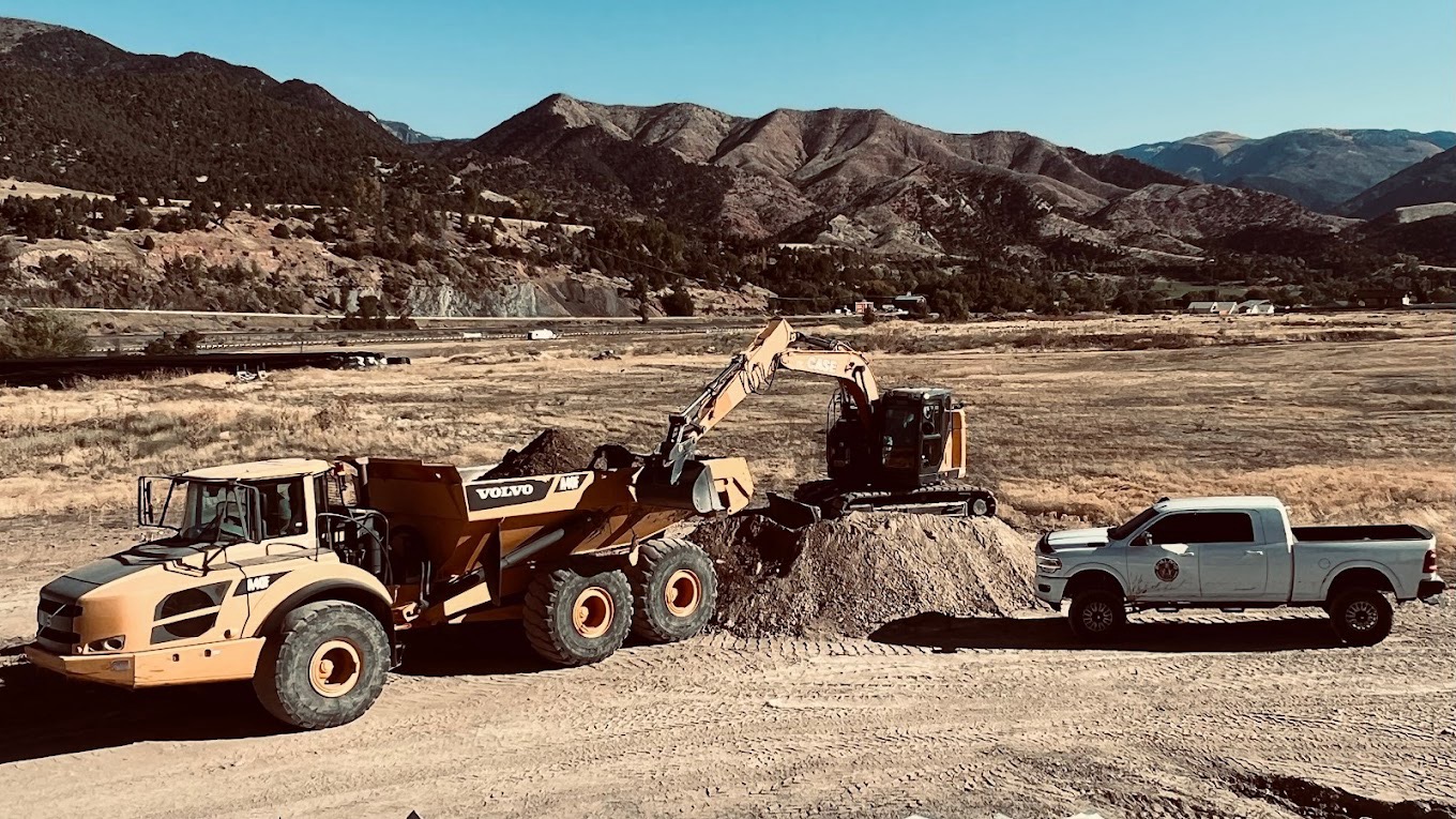 Excavator loading a dump truck on a Bulldog Construction concrete site
